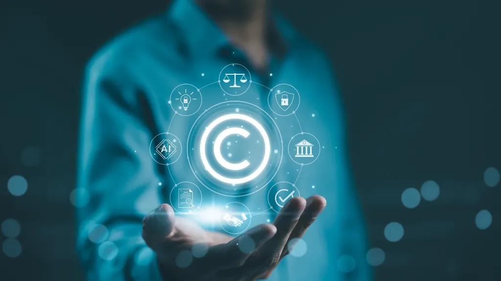 Person in blue shirt holding holographic copyright symbol surrounded by legal and technology icons.